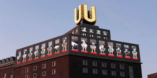 Dortmunder U The Dortmund U with screens and blue sky in the background.